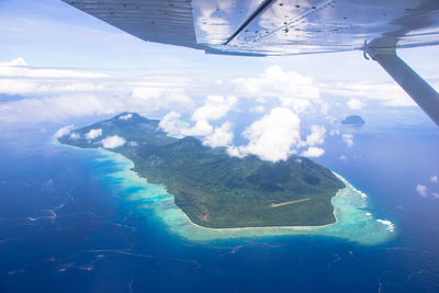 Aerial view of sea and airplane wing