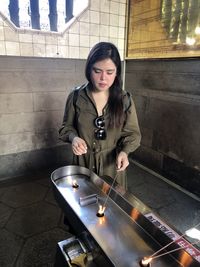 Woman burning incense stick