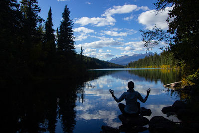 Rear view of man standing in lake