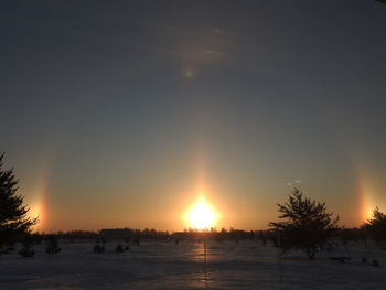 Scenic view of snowy landscape against sky during sunset
