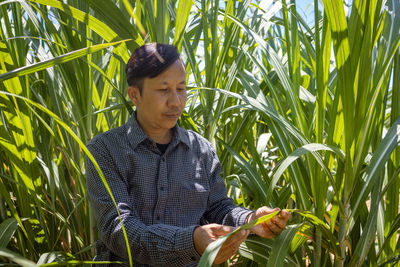 Young man looking away in field