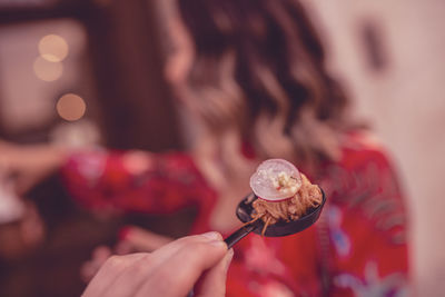 Close-up of woman holding ice cream cone