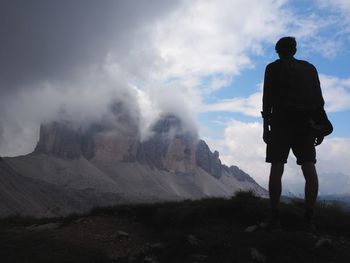 Rear view of man standing on mountain