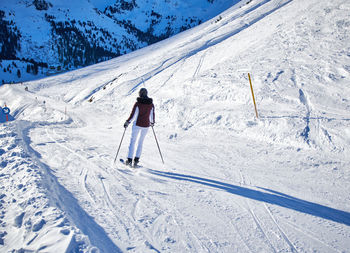 Full length photo of person skiing.