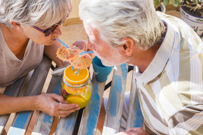 Senior couple enjoying wine at outdoors restaurant