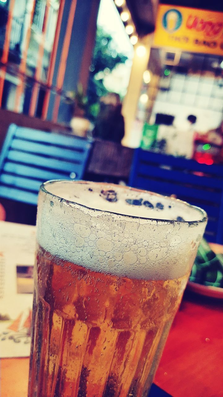 CLOSE-UP OF GLASS OF BEER ON TABLE