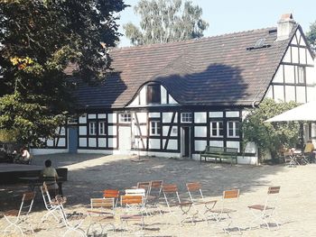 Chairs and table by building against trees