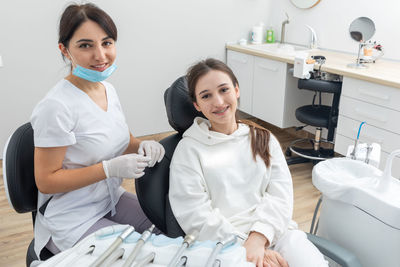 Orthodontist checking brackets on female teeth. concept of stomatology, dentistry, orthodontic