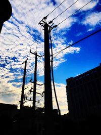 Low angle view of cables against blue sky