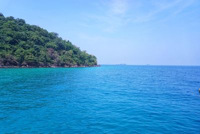 Scenic view of sea against blue sky