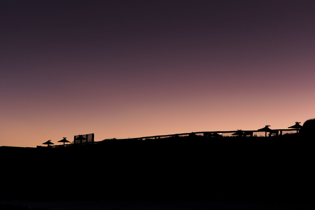 SILHOUETTE BUILDINGS AGAINST SKY DURING SUNSET