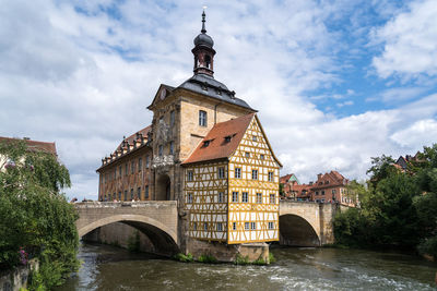 Arch bridge over river against buildings