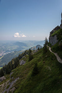 Scenic view of sea and mountains against blue sky