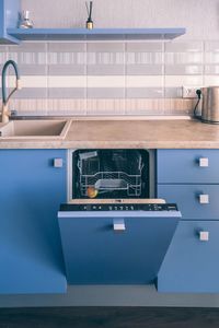 Kitchen interior design and opened dishwasher machine