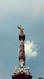 Low angle view of statue against sky