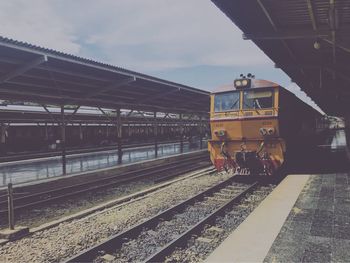 Train on railroad station platform against sky