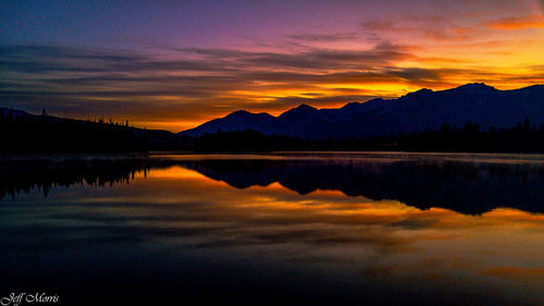 Scenic view of lake against romantic sky at sunset