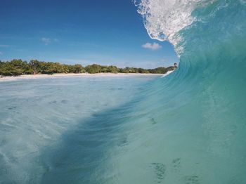 Man surfing on waves in sea