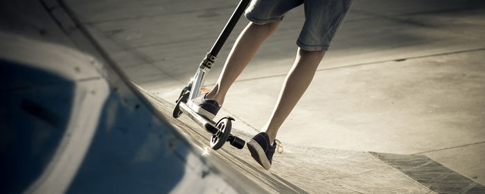 Low section of boy skateboarding on ramp outdoors