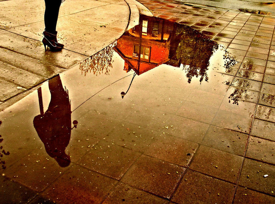 low section, street, puddle, person, lifestyles, paving stone, high angle view, reflection, sidewalk, wet, walking, water, cobblestone, men, leisure activity, shadow, building exterior, rain