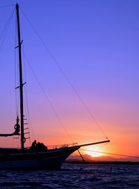 Boats in sea at sunset