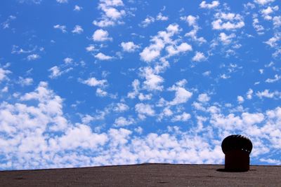 Silhouette boy against blue sky