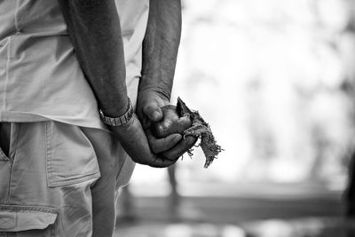 Midsection of man holding ball