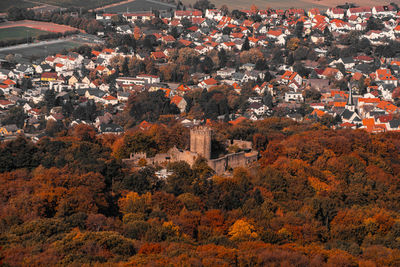 High angle view of trees and buildings in town during autumn