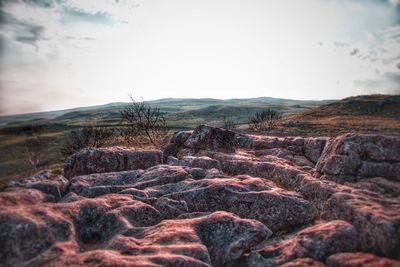 Scenic view of rocks on land against sky