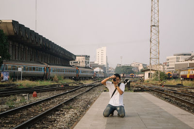 Rear view of woman walking on railroad station