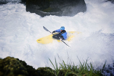 High angle view of male kayaker in river