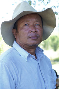 Alone old thai man with dark skin, bearded face, indigenous close-up