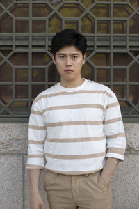 Portrait of young man standing outdoors