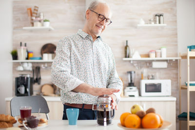 Midsection of man preparing food in kitchen at home