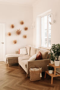 Scandinavian bright interior of a living room with a sofa and eco friendly decor in a cozy apartment