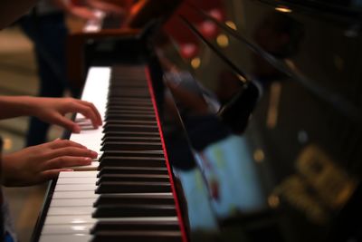 Close-up of hands playing piano