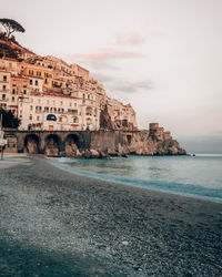 A beautiful sunset at a pebbles beach in amalfi, italy