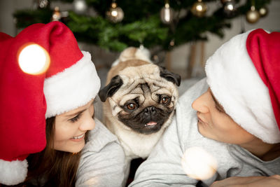 Couple with dog during christmas at home
