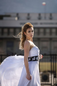 Portrait of young woman standing outdoors