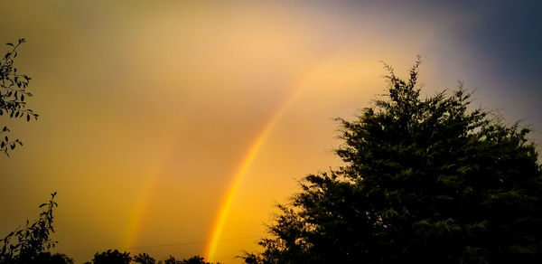 Scenic view of rainbow against sky during sunset