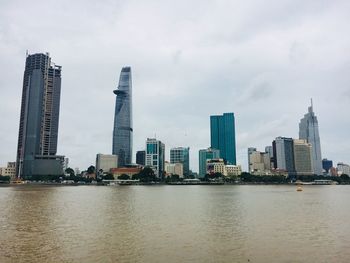 View of buildings in city against cloudy sky