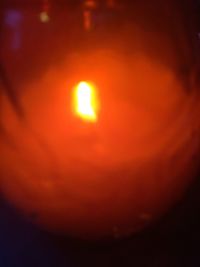 Close-up of illuminated orange sun at sunset