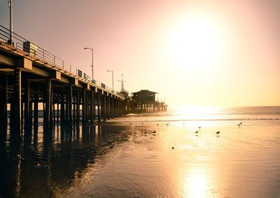 Scenic view of pier against clear sky during sunset