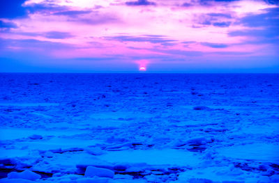 Scenic view of sea against sky at sunset