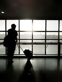 Silhouette of man standing at airport