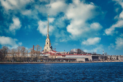 Tower of buildings against cloudy sky