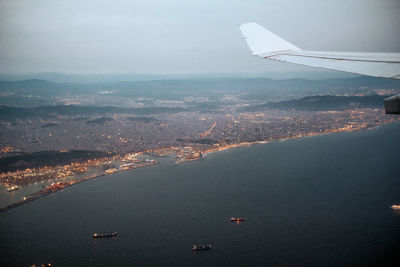 Aerial view of sea and mountains against sky