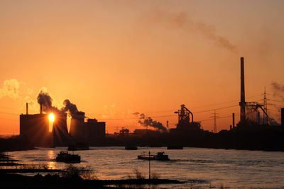 Silhouette ship in sea against sky during sunset