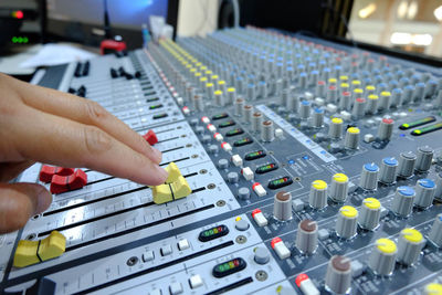Cropped hand mixing music in recording studio