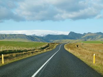 Road passing through landscape against sky